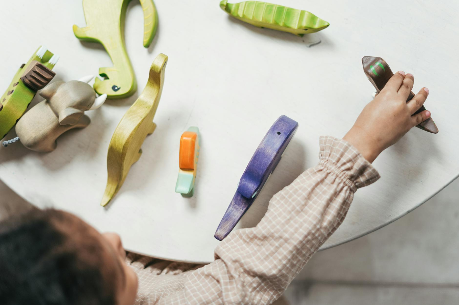 person holding purple and yellow plastic tool